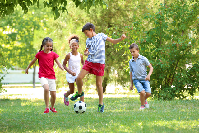 group of 4 children playing outside