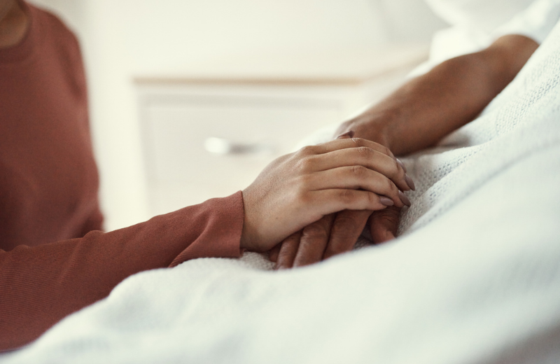 couple holding hands in the hospital showing support