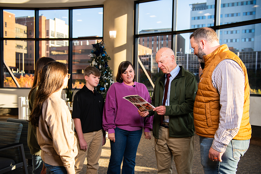 Richard Davis, M.D., and the Jones family reflects on pictures from their time in the UAB CCN.